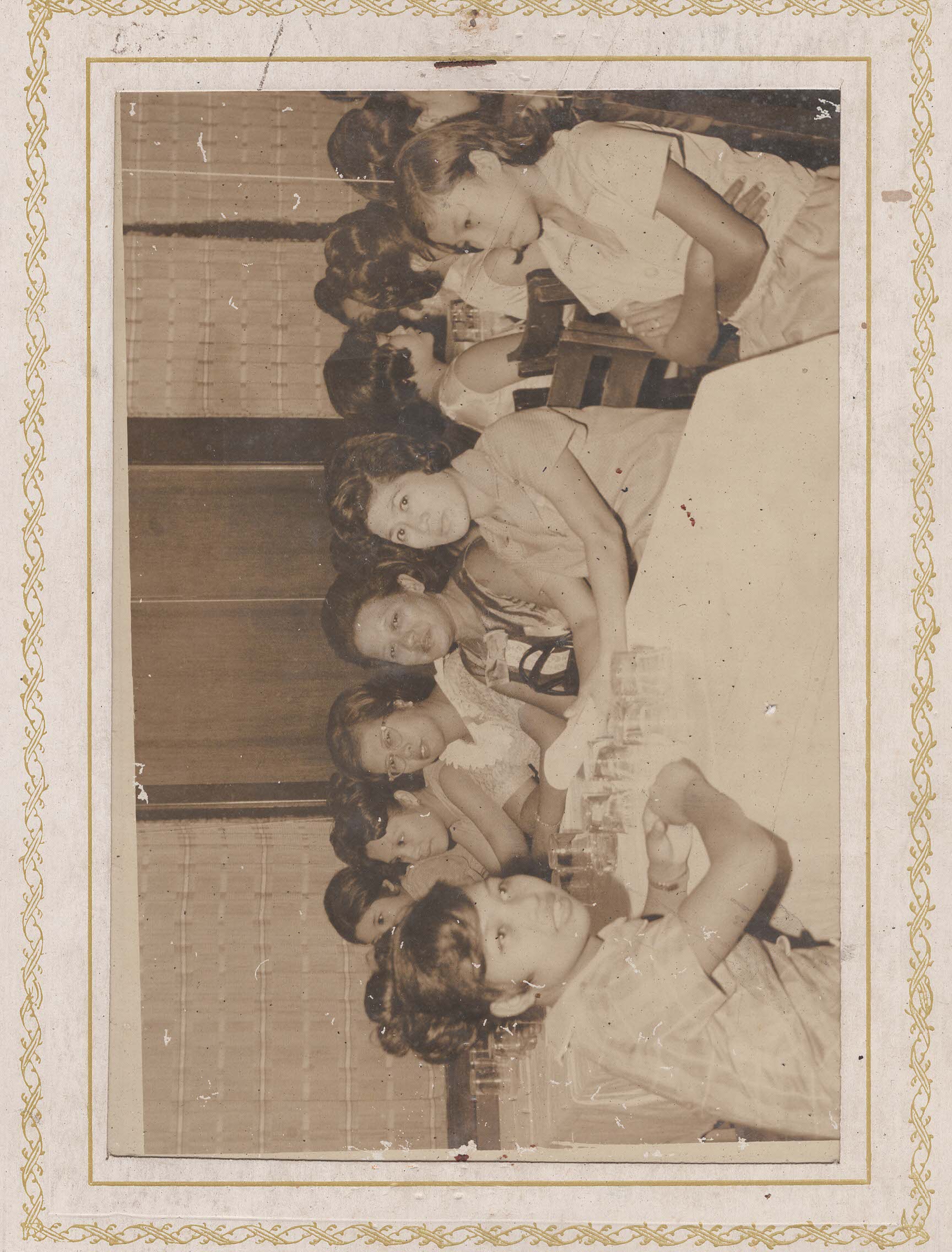 A long table of women at a banquet