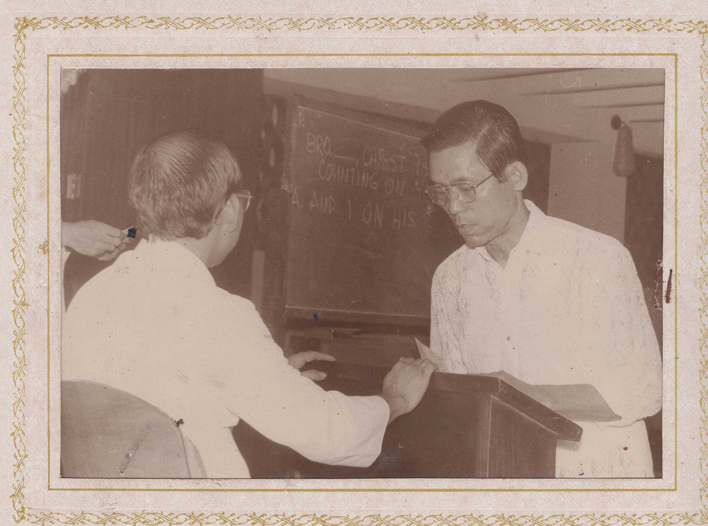 Two men at a lectern, one appears to be taking an oath