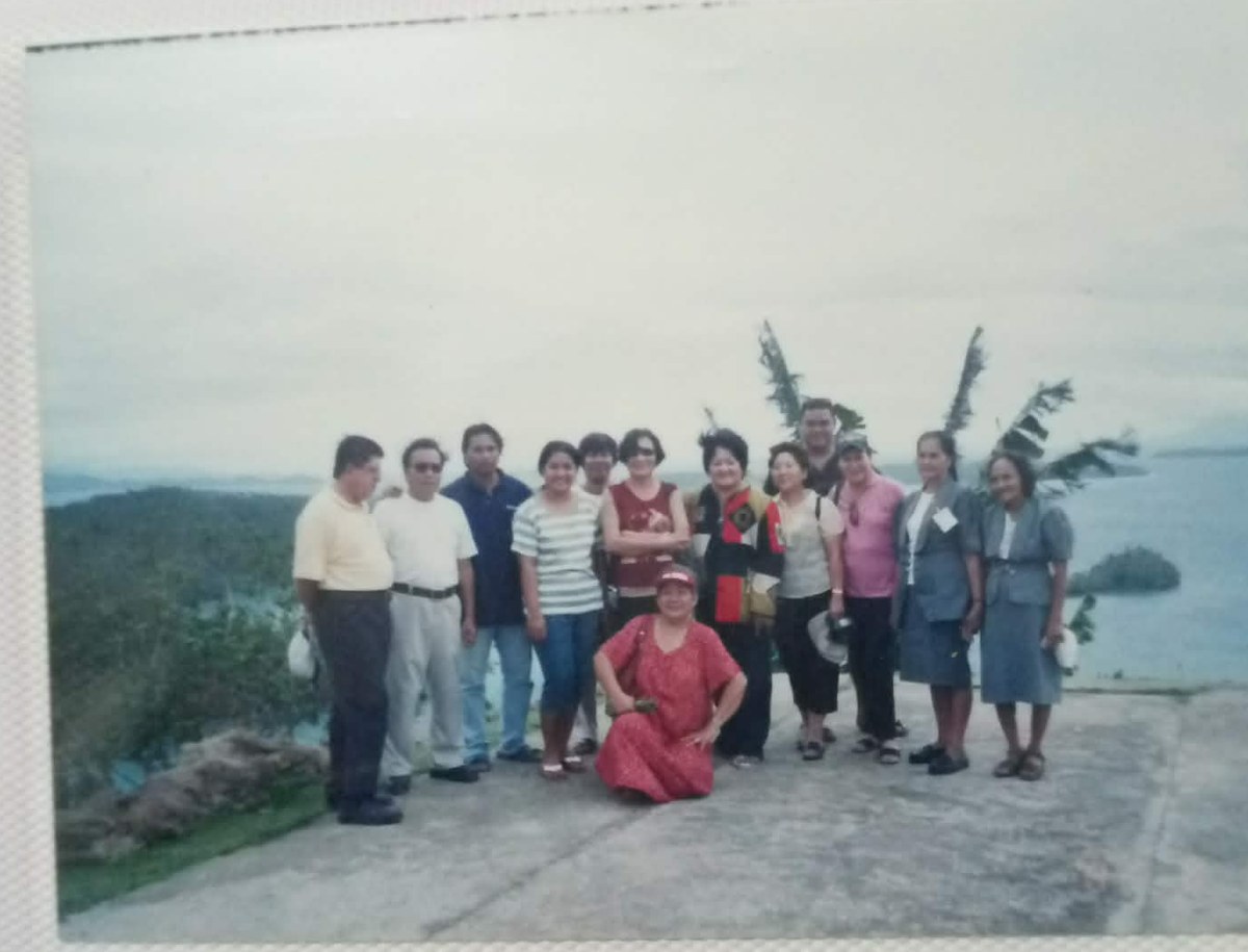 A family group visiting Dinagat Island, overlooking the water